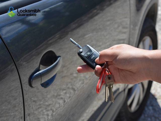 Technician at a car door with a diagnostic tool resting on the sill