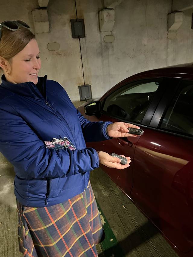 Newly cut car key handed across to its owner