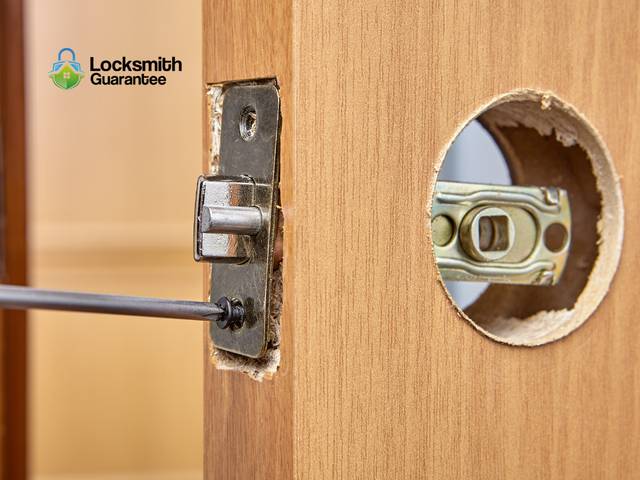 Old deadbolt coming off and its replacement going on