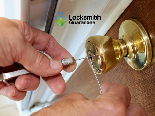Locksmith working on a front door lock for someone shut out