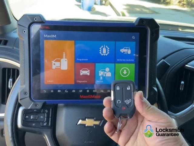Key fob wired to a programming tool on a car seat