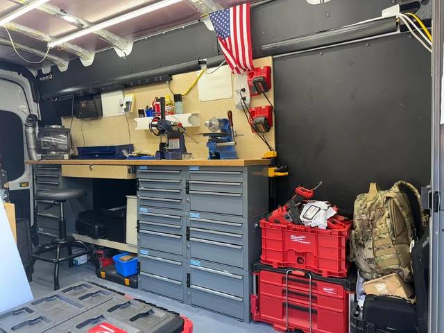 Inside the van: key machines, blanks and tools racked along the side