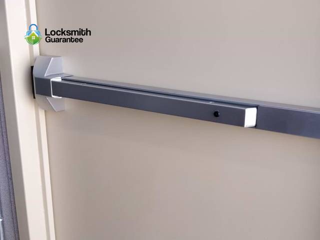 Two exit devices side by side, showing the push pad and the latch