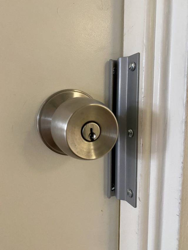 Latch guard fitted over the gap at a house door edge