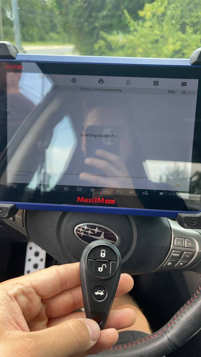 Subaru key fob being coded to the car