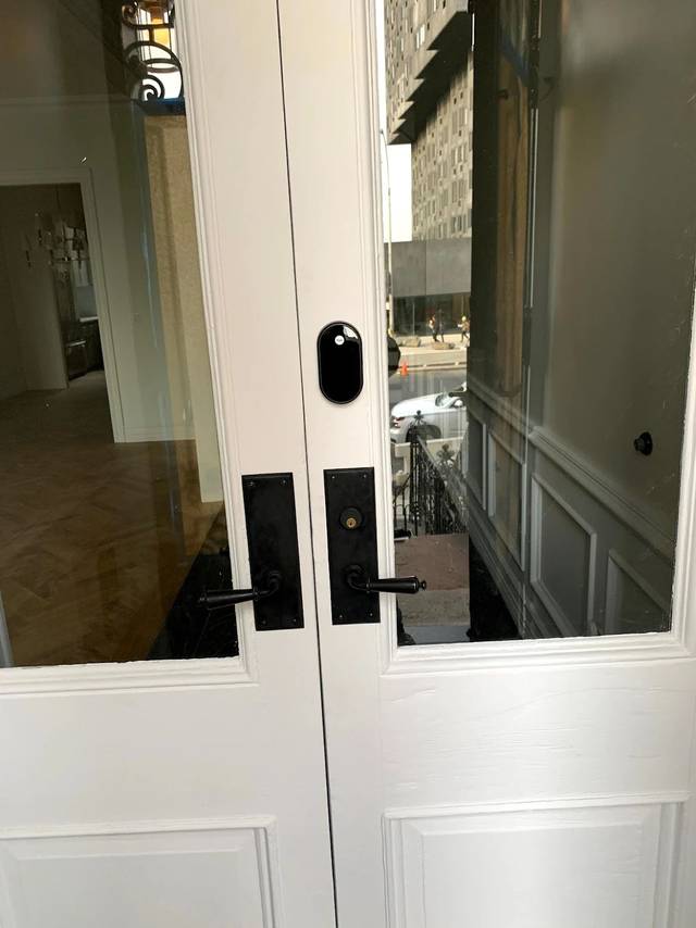 Yale smart lock on a white painted door