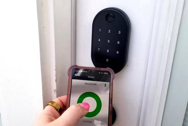 Yale lock being paired with its phone app after fitting